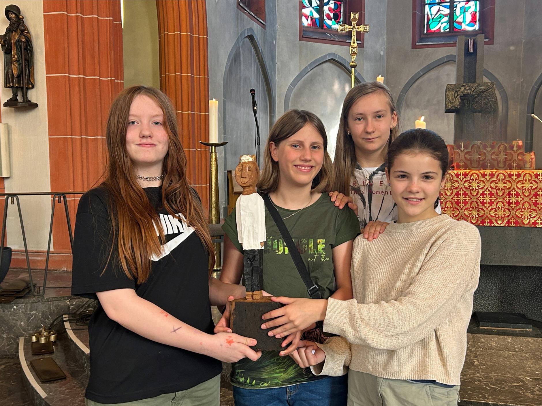 Vier Schülerinnen der Marienschule freuen sich über den Besuch der Königsfigur.