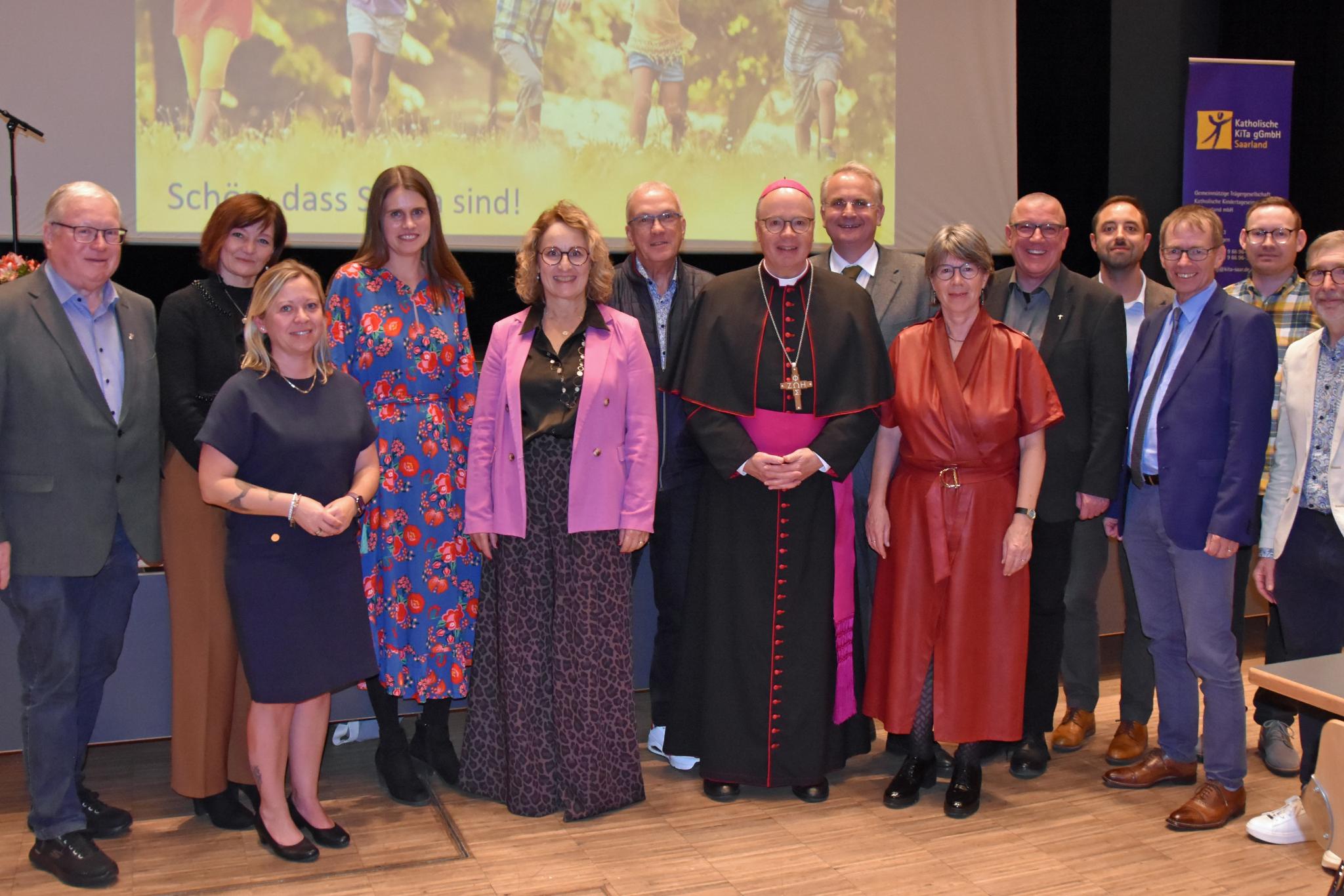 Der Aufsichtsrat der Katholischen KiTa gGmbH und Gäste aus Politik und Kirche, darunter Staatssekretärin Jessica Heide, Bischof Stephan Ackermann, Vertreter von Landkreis und Kommunen sowie die Geschäftsführerinnen der Katholischen KiTa gGmbH Saarland.