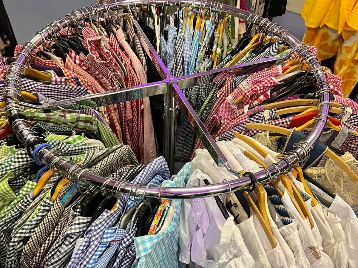 Eine Kleiderstange mit vielen bunten Hemden in unterschiedlichen Farben.