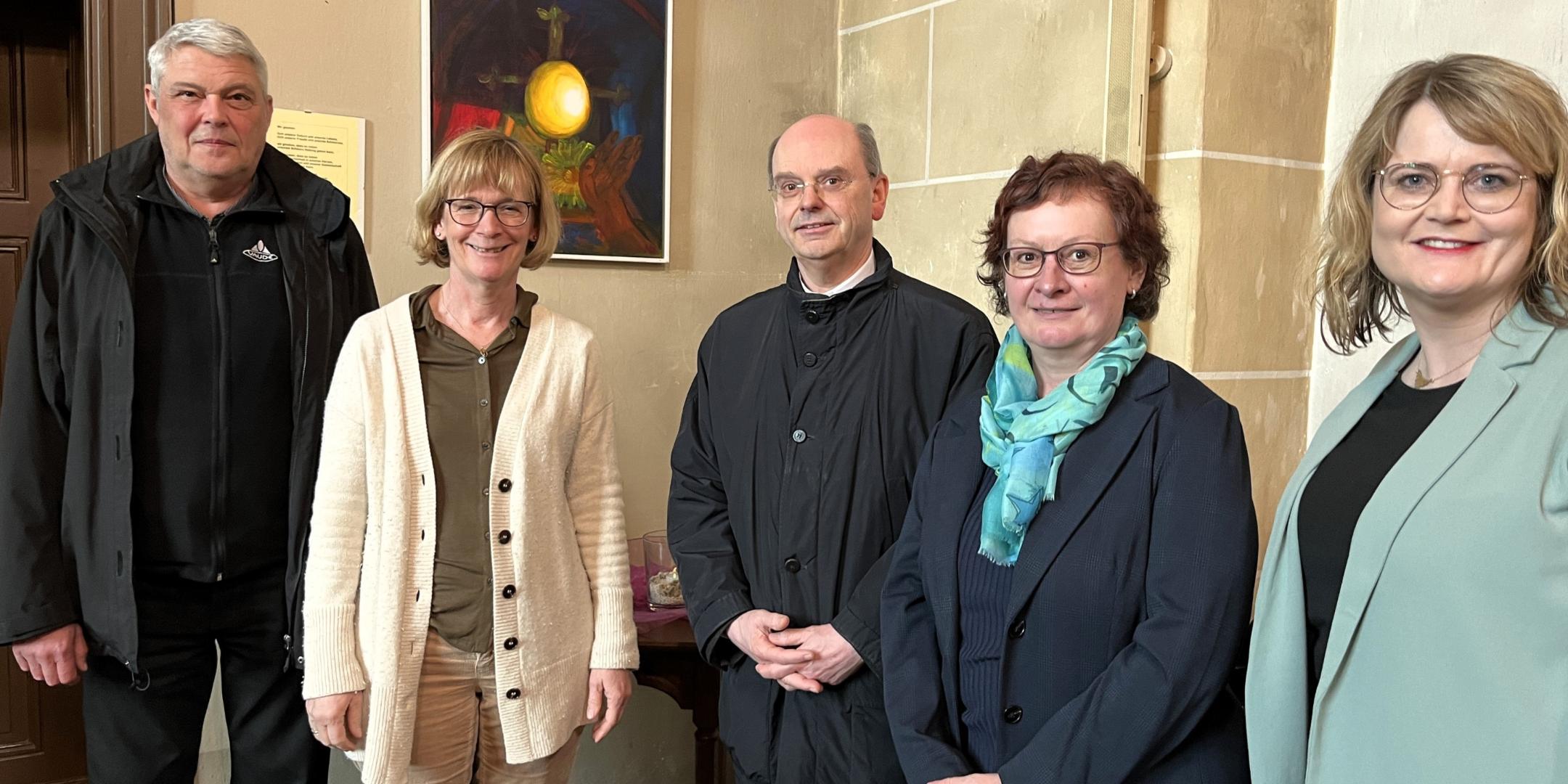 Der Trierer Weihbischof Robert Brahm (Mitte) besuchte gemeinsam mit seiner Referentin Katja Neff (Zweite v. rechts) und Dekan des Pastoralen Raums Eric Condé (links) die Klinikseelsorgerinnen Marion Jensen (Zweite v. links) und Melanie Kammerer (rechts). In der Kirche der Rhein-Mosel-Fachklinik Andernach betrachtete die Gruppe unter anderem ein Gemälde, das von einer Patientin hergestellt wurde.