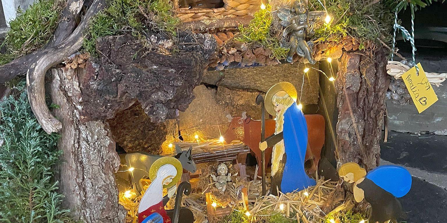 Mit einer kleinen Lichterkette illuminierte Weihnachtskrippe.