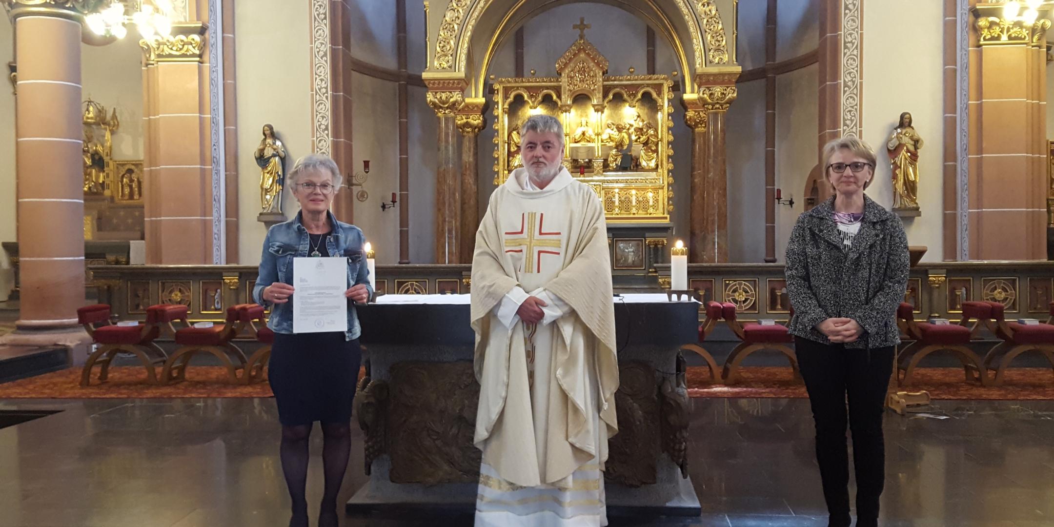 Am 7. Juni überreichte Pfarrer Franz-Josef Werle in Vertretung für Bischof Ackermann Ursula Gluch (l.) die Beauftragung zum Bestattungsdienst. Begleitet wurde sie dabei von Judith Schreiner (r.) als Vertreterin des ambulanten Hospiz St. Michael, Völklingen, wo Ursula Gluch im Rahmen ihres ehrenamtlichen Einsatzes ebenfalls beauftragt ist. (Foto: Georg Gluch)