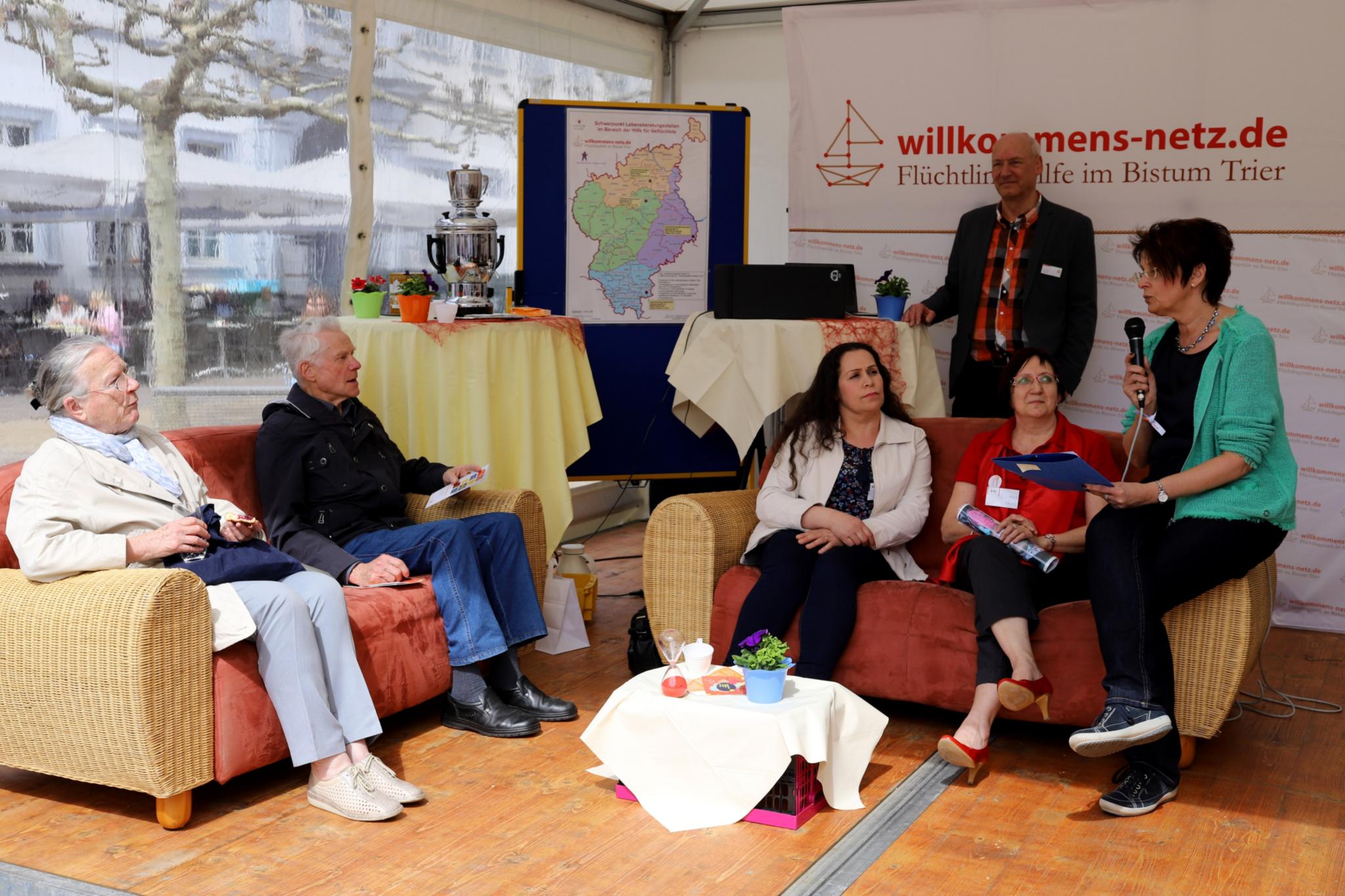 Am Stand des 'Willkommensnetzes - Flüchtlingshilfe im Bistum Trier' gaben Ehrenamtliche persönliche Statements zu ihren Erfahrungen. So auch Rita Monz (2. v.r.) und ihre Freundin Naliah Boulous (3.v.r.) aus Syrien