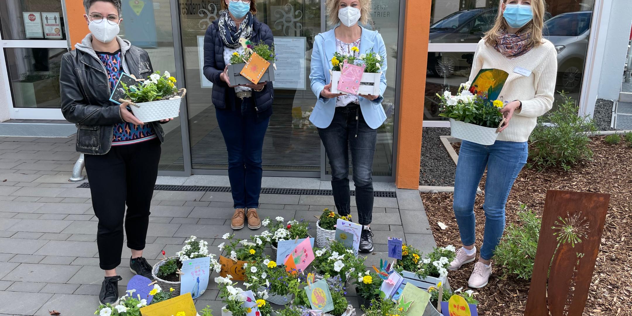 Melanie Teixeira, Brunhilde Steinmetz, Katja Neisius-Umbscheiden (Remise) und Frederike Hassel, Sozialdienstleiterin Seniorenresidenz Sankt Peter, freuen sich über die Blumengrüße der Ehranger Familien für die Senioren.