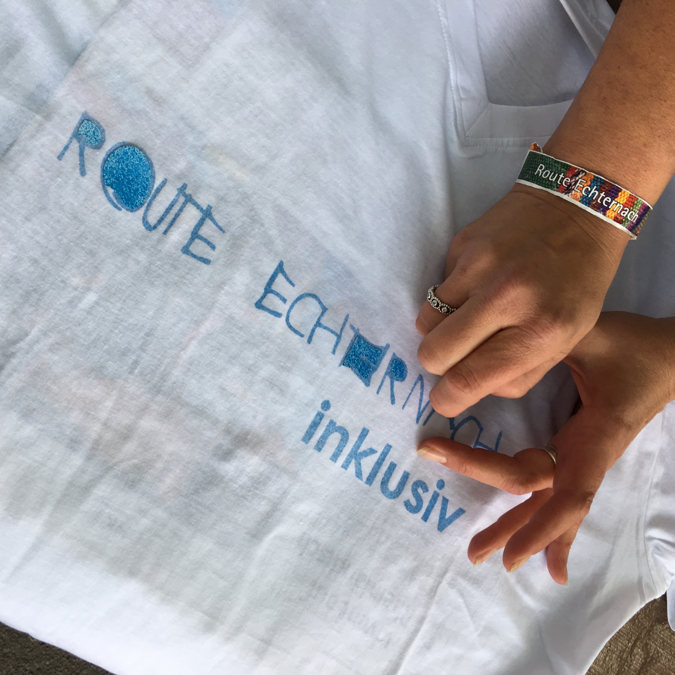 Hände basteln an einem Tshirt.
