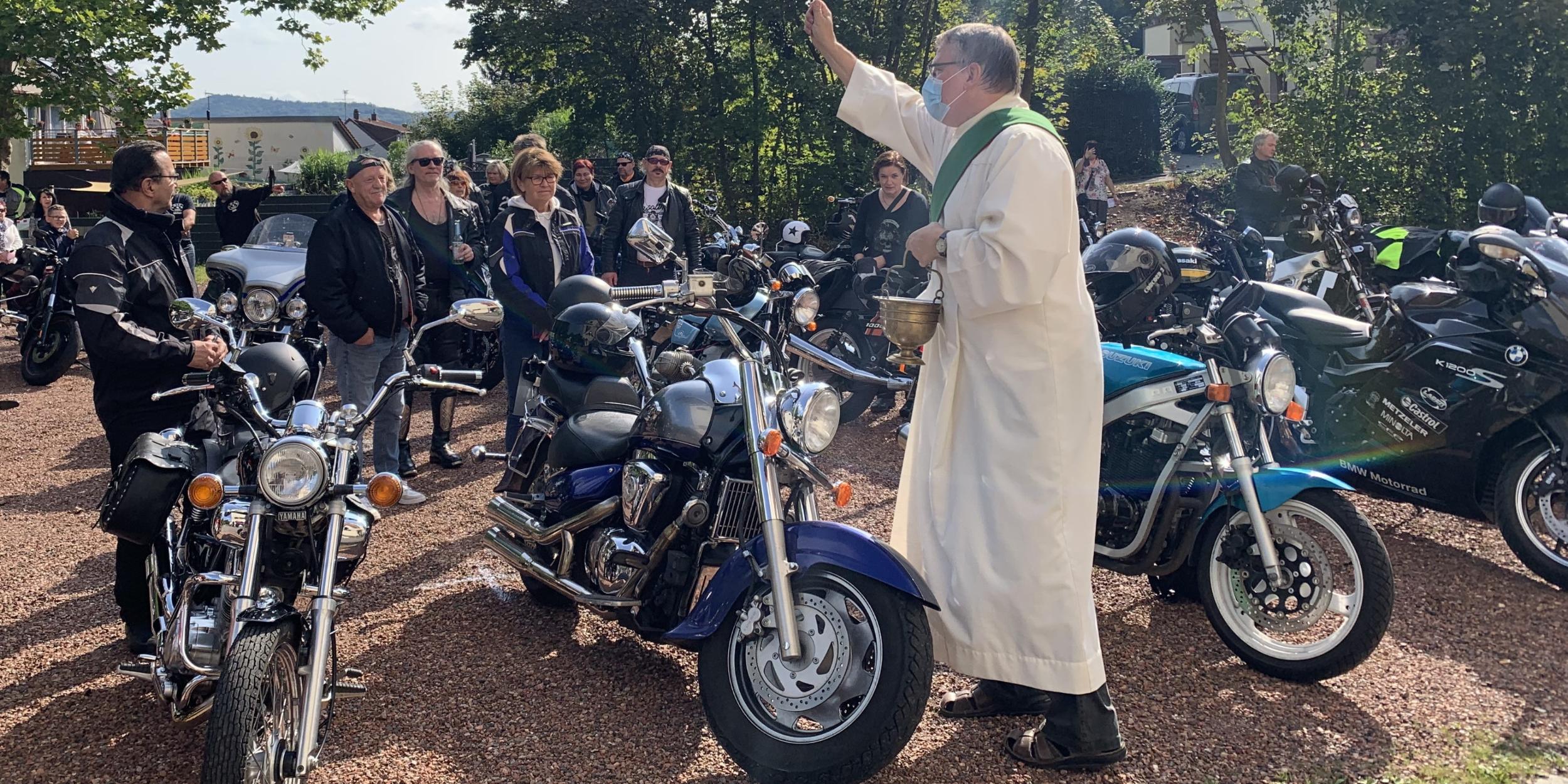 Diakon Gerd Fehrenbach segnet die Motarradfahrerinnen und Motorradfahrer. Foto: Ute Kirch/Bischöfliche Pressestelle Saarbrücken